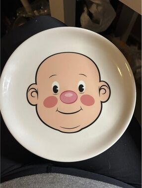 Fred plays with his food plate